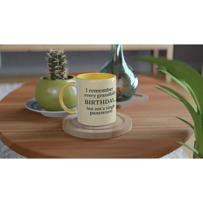 Grandkids > Passwords Mug – White 11oz ceramic with yellow interior on a wooden table.